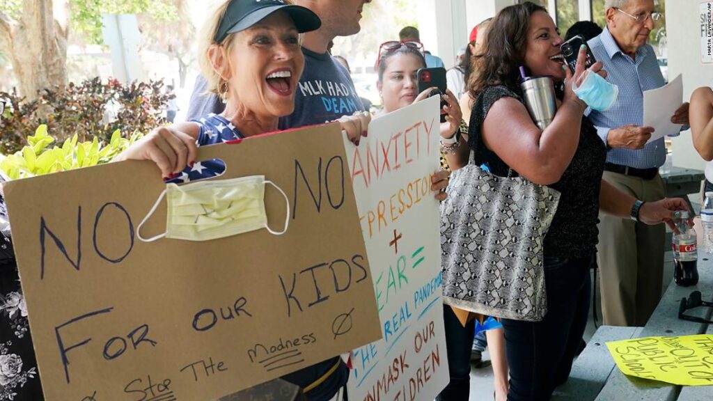 As Covid-19 cases surge in Florida, governor says parents should decide whether their children wear masks to school