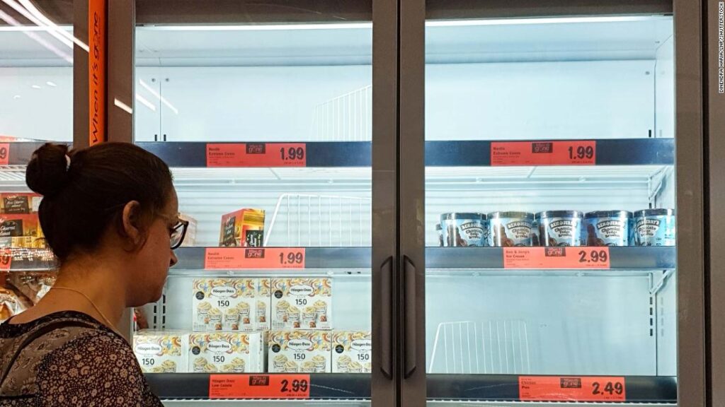 A customer looks at the depleted stock of ice cream at a Lidl supermarket.