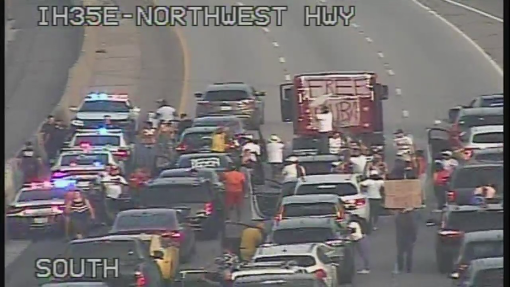 Demonstrators Block Traffic On I-35E In Dallas In Support Of Cuban Protests
