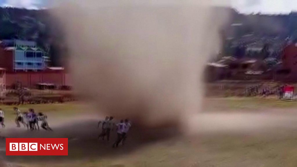 Dust devil almost takes out football players