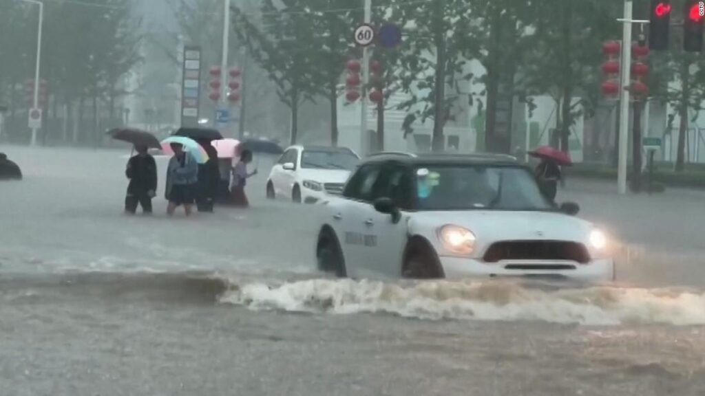 Heavy rainfall floods streets and subway stations in China - CNN Video